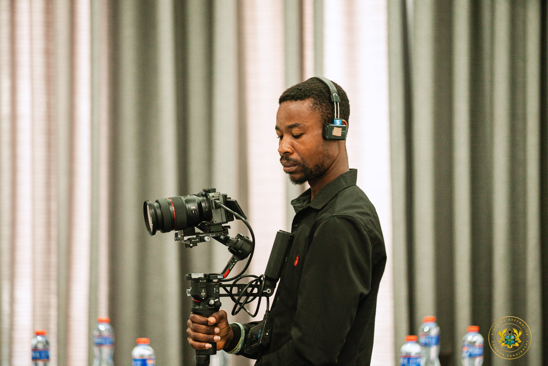 Camera operator preparing equipment at an event