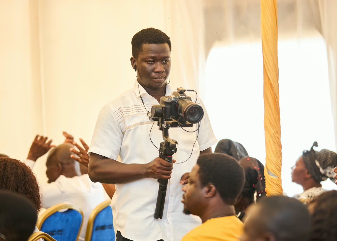 Camera operator filming among event guests