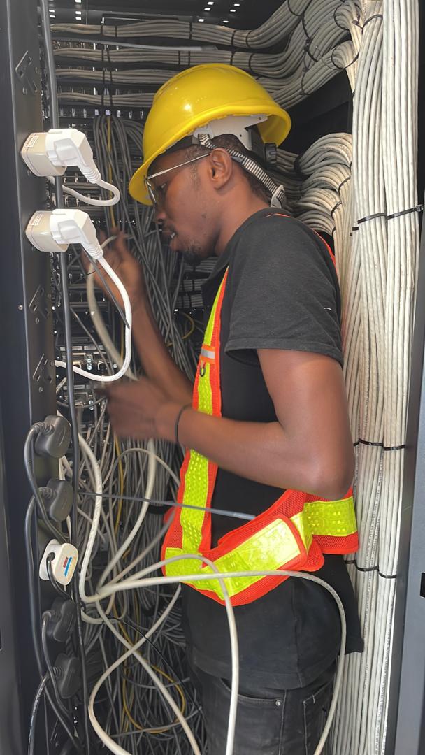 Technician working on communications cabling